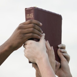 bible with hands
